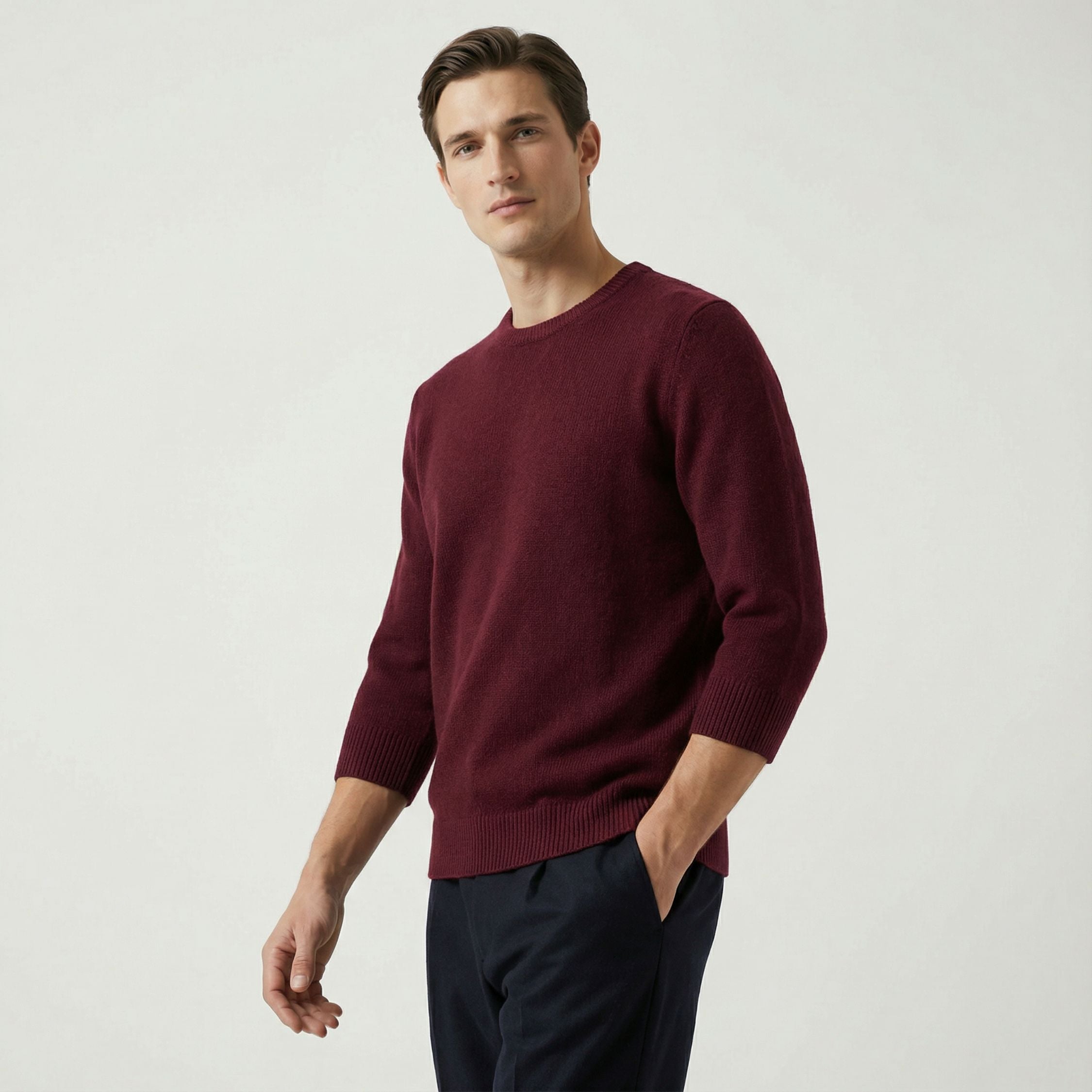 Male model wearing a maroon red, regular-fit 3 quarter sleeve sweater made of 100% cashmere pashmina, paired with black trousers.