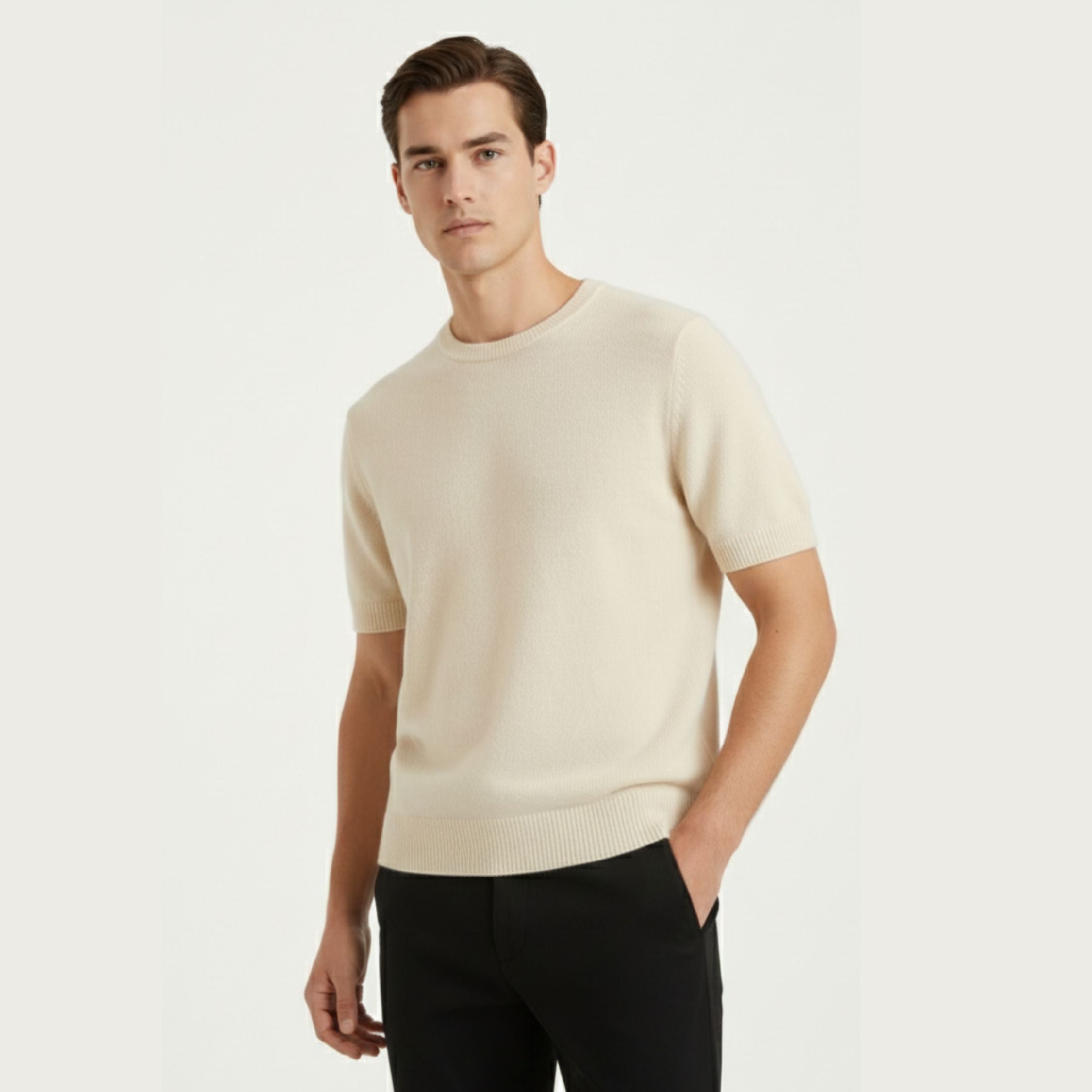 Male model wearing a Cream White regular-fit knitted T-shirt made of 100% cashmere pashmina, paired with Black trousers.