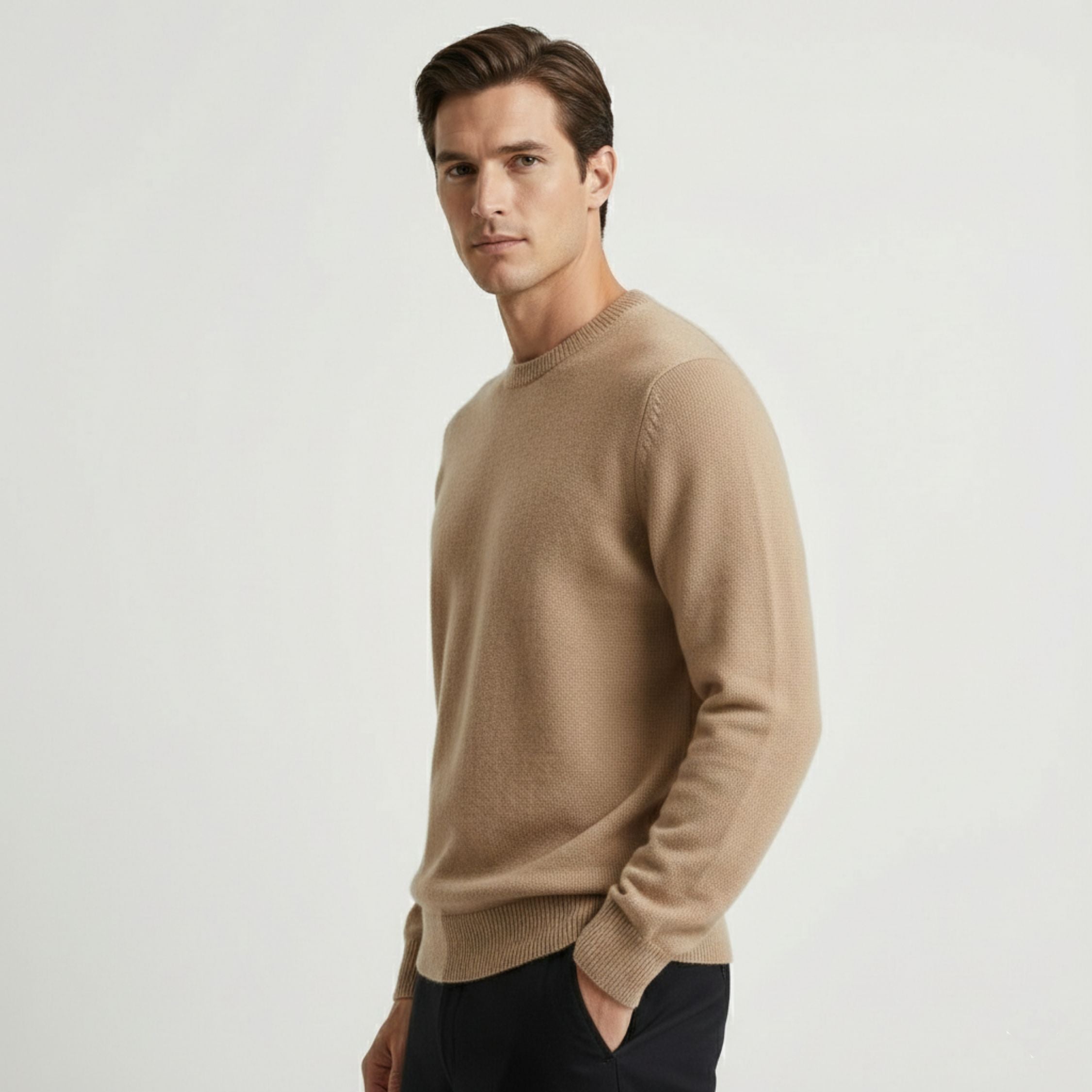 Male model wearing a Beige, regular-fit knitted sweater made of 100% cashmere pashmina, paired with black trousers.
