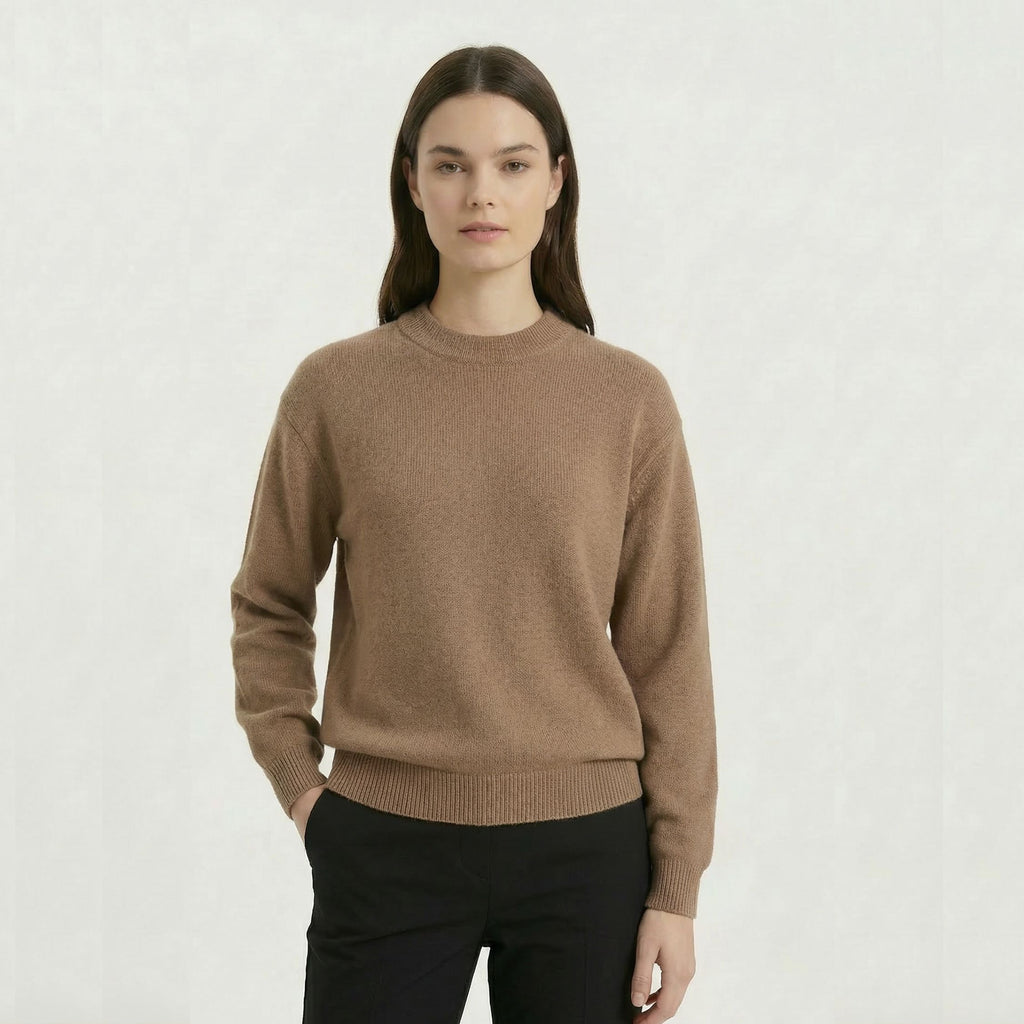 Female model wearing a Beige, regular-fit relaxed-arm sweater made of 100% cashmere pashmina, paired with black trousers.