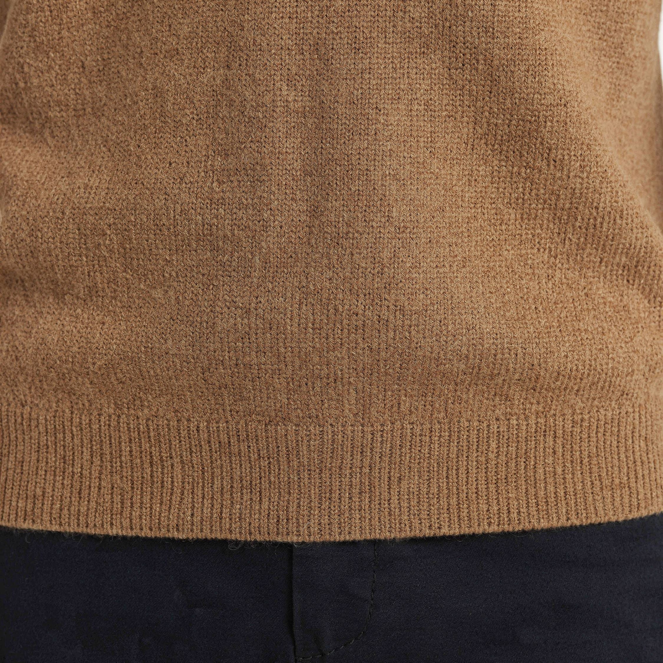 Close-up of a brown knitted 100% Cashmere sweater with a white background.