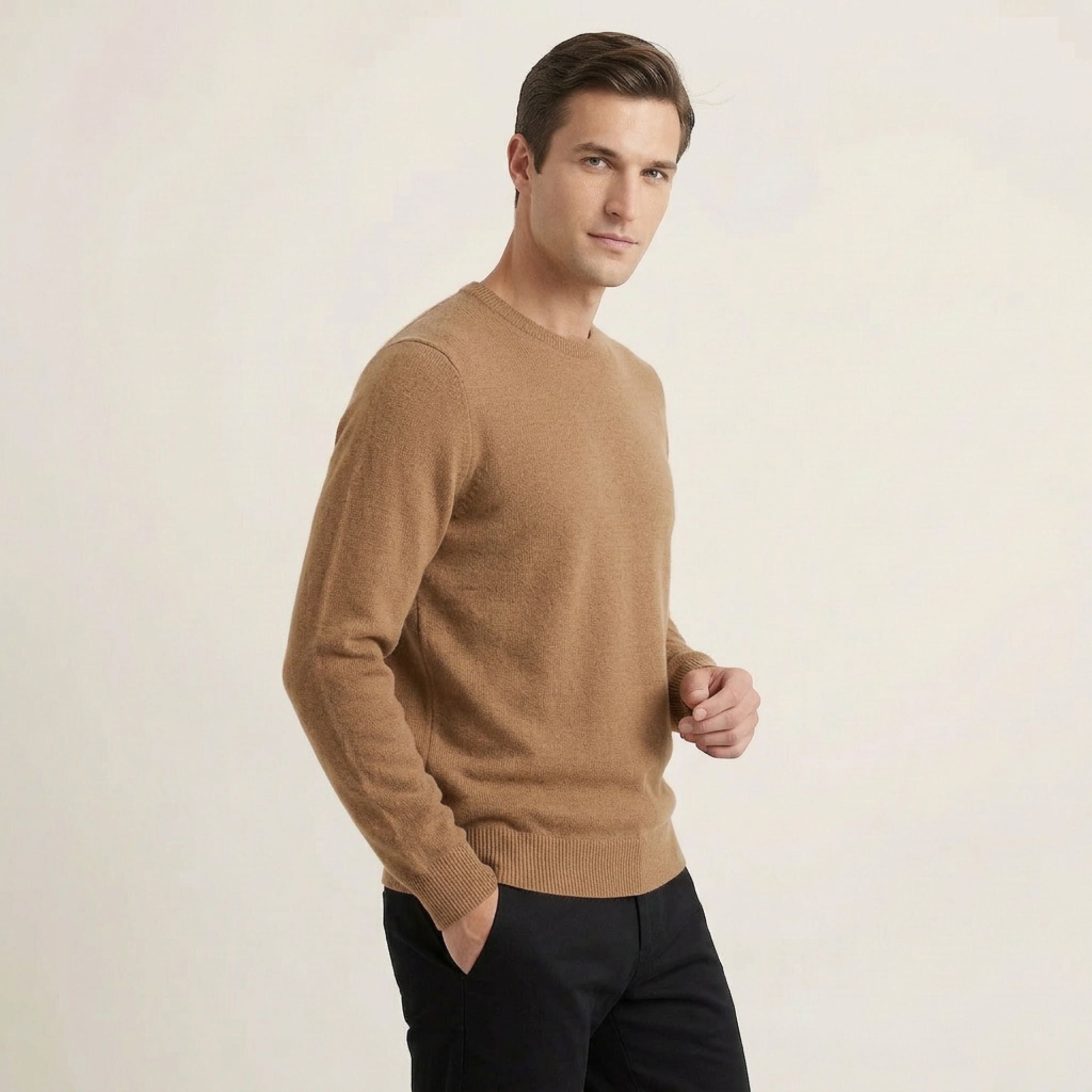 Man wearing a brown 100% Cashmere sweater against a plain background.