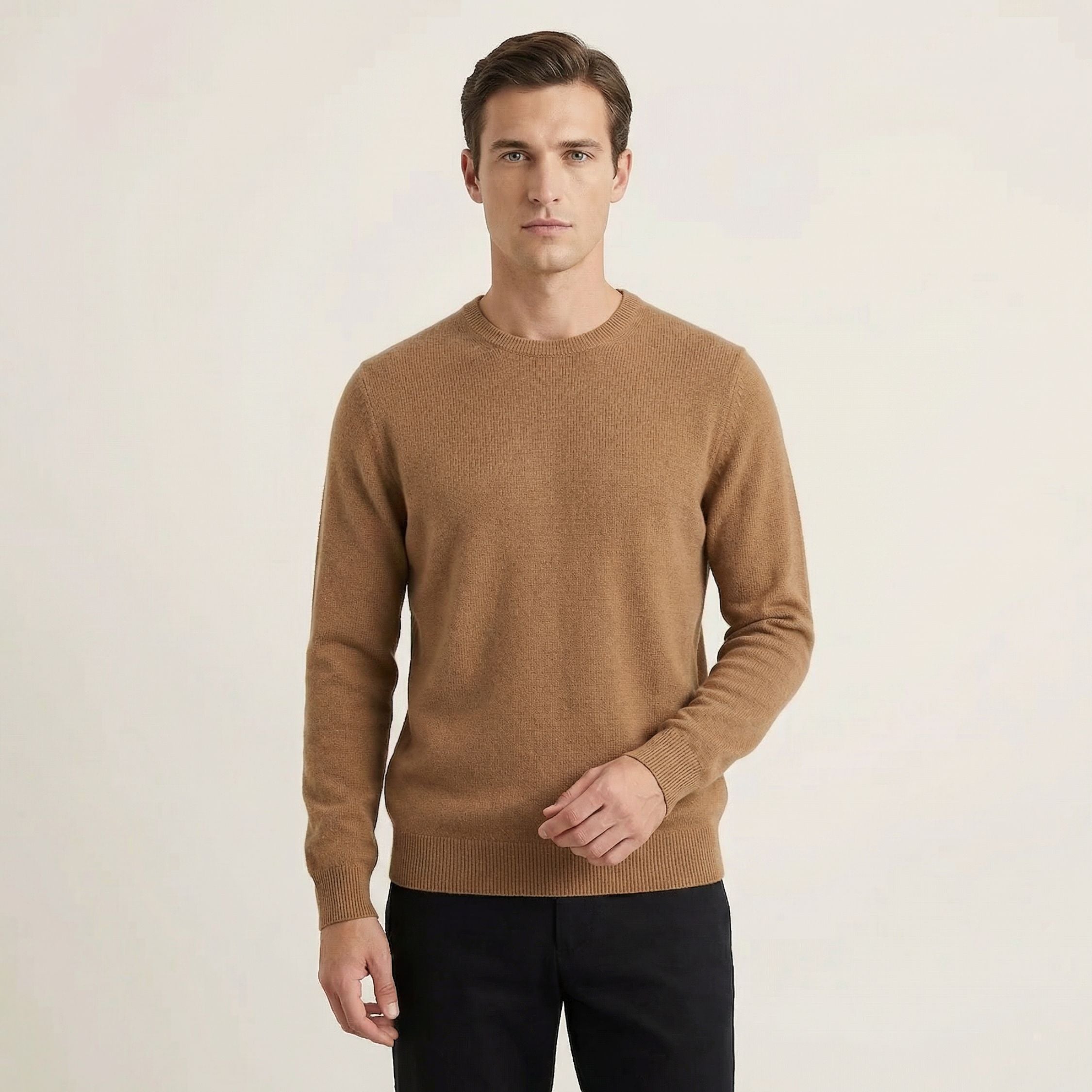 Man wearing a brown 100% Cashmere sweater on a plain background.