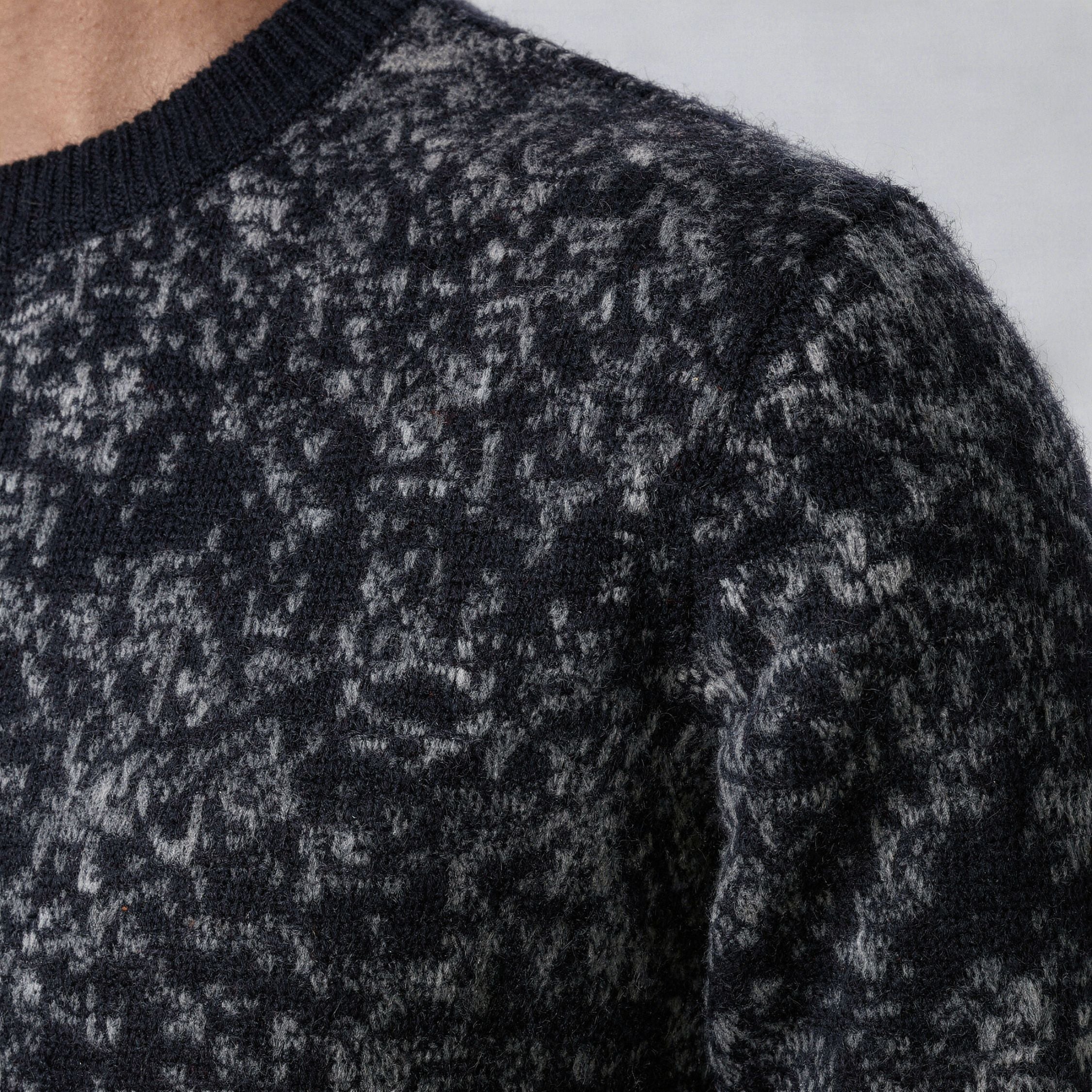 Close-up of a textured black and gray 100% cashmere sweater