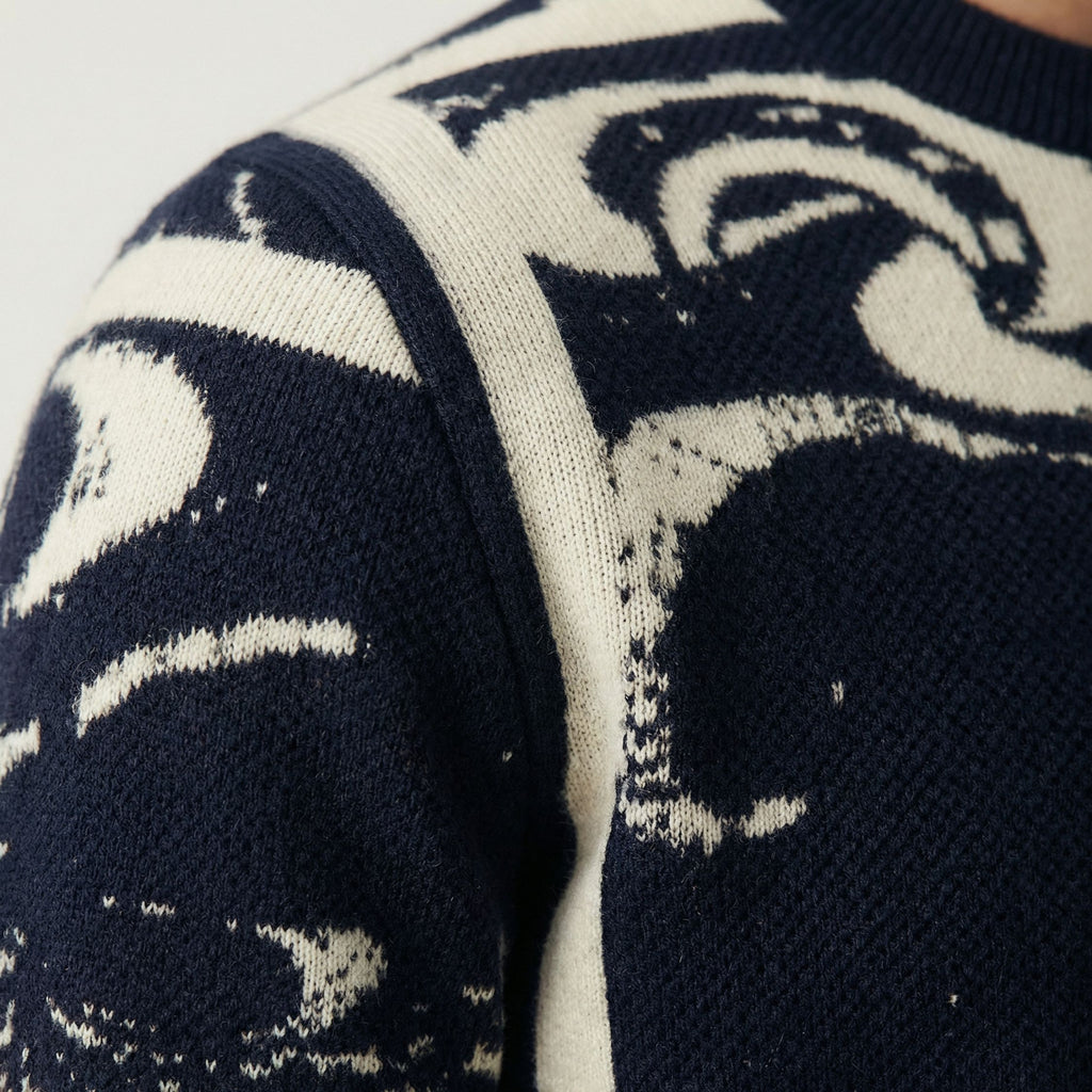 Close-up of a 100% cashmere navy blue sweater with white abstract pattern
