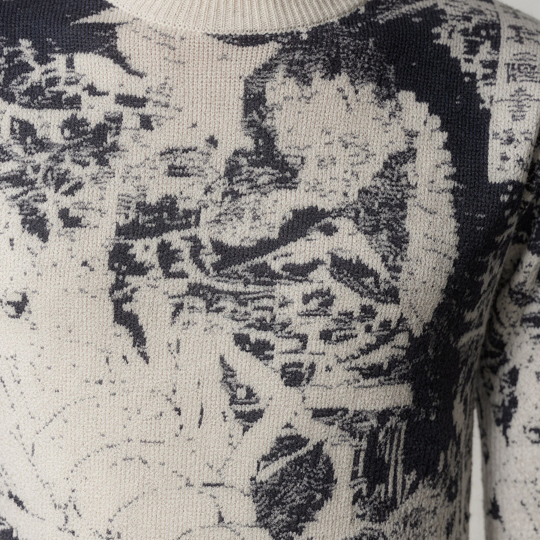 Close-up of a textured 100% cashmere sweater with a patterned design.
