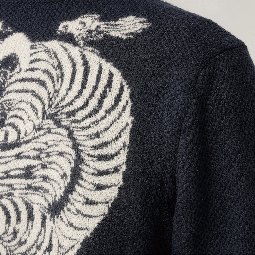 Black 100% cashmere sweater with zebra pattern on a plain background