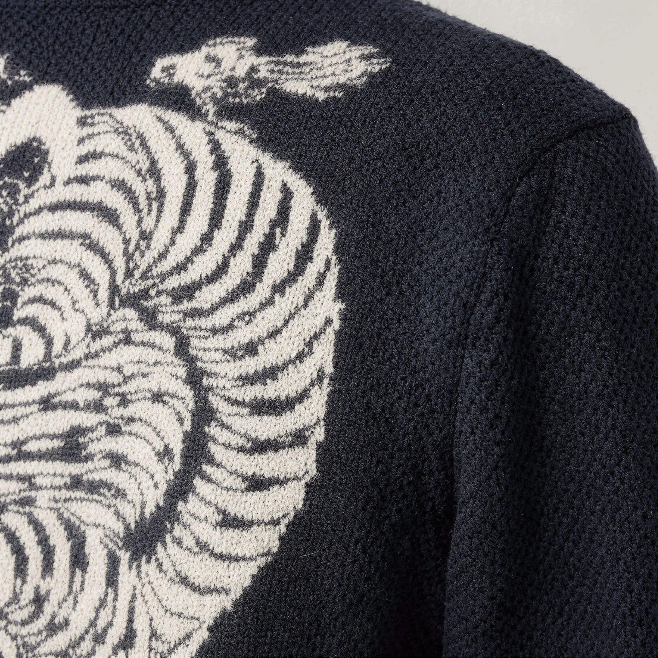 Black 100% cashmere sweater with zebra pattern on a plain background