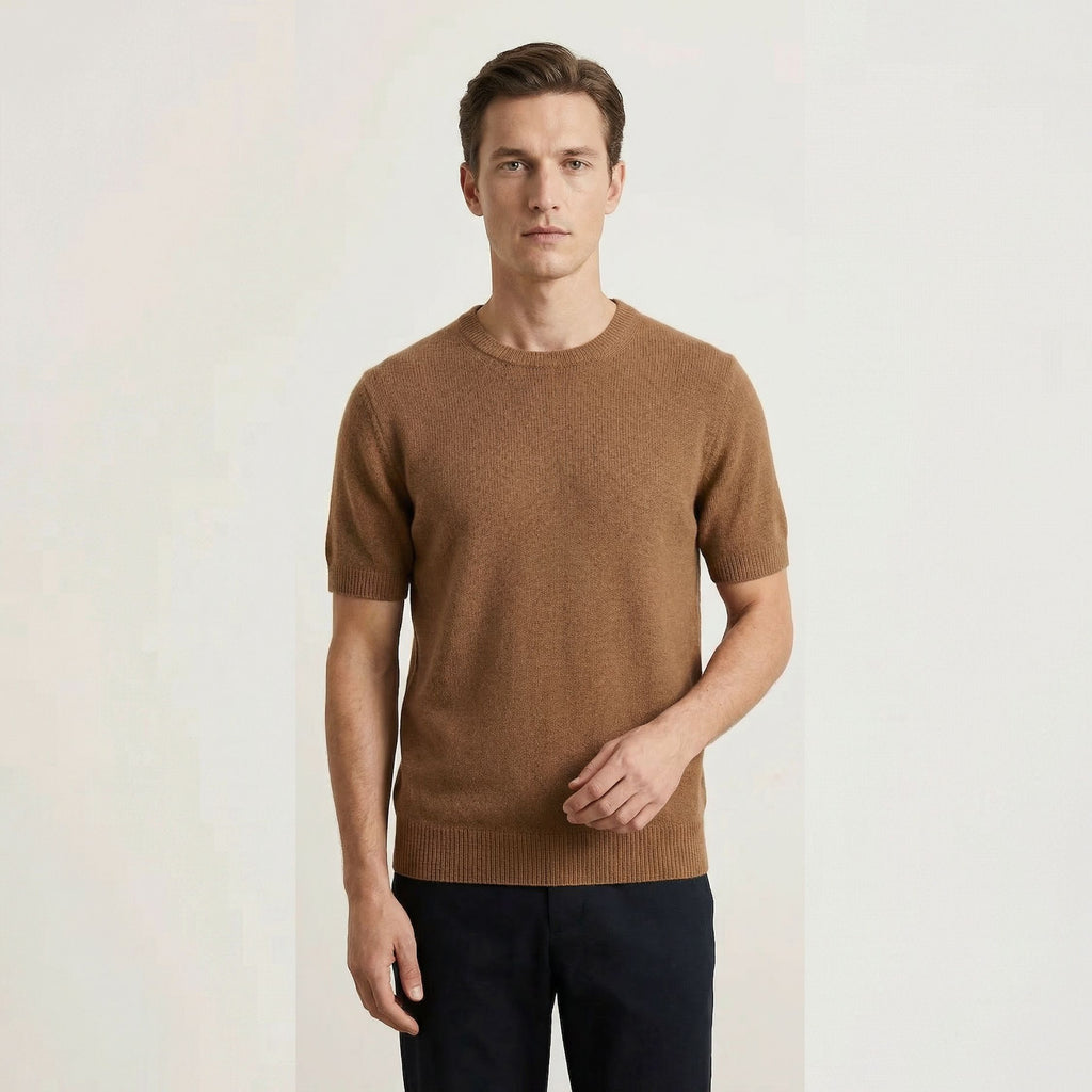 Man wearing a brown 100% cashmere sweater against a plain background.
